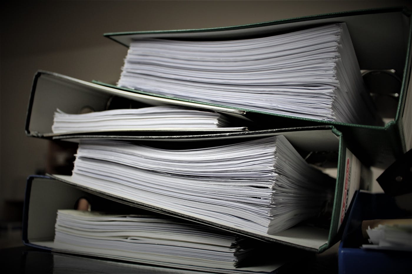 Stacks of business papers and folders waiting to be organized.